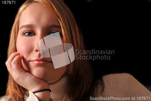 Image of Attractive young woman with her chin resting on her hand