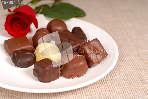 Image of Variety of chocolates and a rose on a white plate