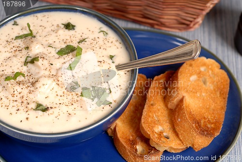Image of Overhead view of New England Clam Chowder in a blue bowl
