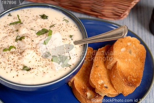 Image of Overhead view of New England Clam Chowder in a blue bowl