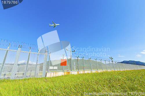 Image of Airplane fly over grass in Hong Kong
