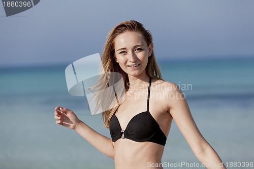 Image of Young woman with bikini on the beach, laughing Portrait Landscap