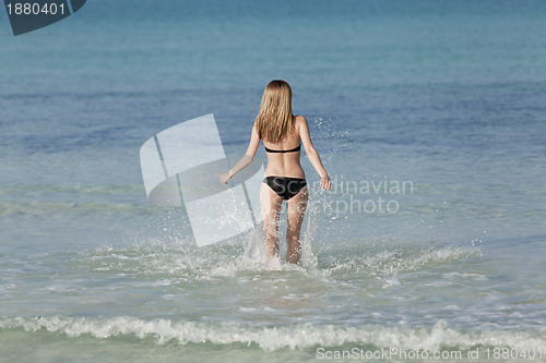 Image of Woman with bikini in the sea jumping landscape