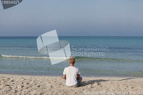 Image of Man making yoga on the beach Sports Landscape