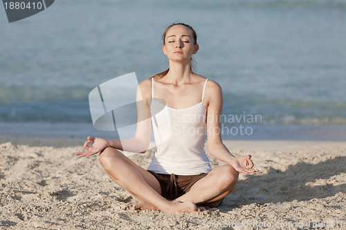 Image of Woman doing yoga on the beach Sports Landscape