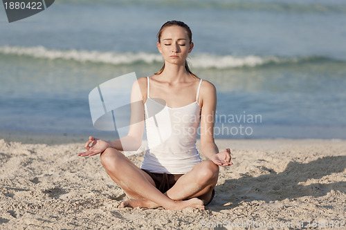 Image of Woman doing yoga on the beach Sports Landscape