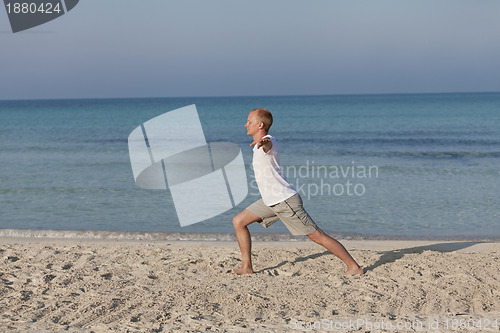 Image of Man making yoga on the beach Sports Landscape