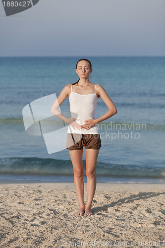 Image of Woman doing yoga on the beach Sports Portrait