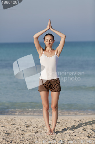 Image of Woman doing yoga on the beach Sports Portrait