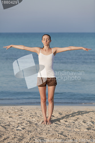 Image of Woman doing yoga on the beach Sports Portrait