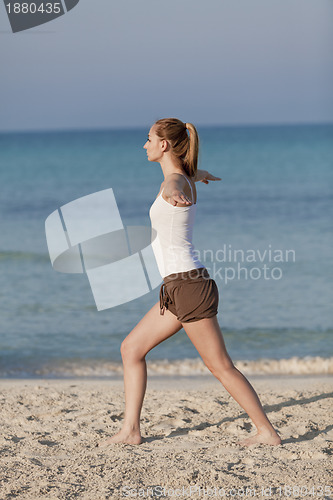 Image of Woman doing yoga on the beach Sports Portrait