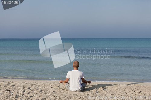 Image of Man making yoga on the beach Sports Landscape