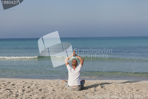 Image of Man making yoga on the beach Sports Landscape