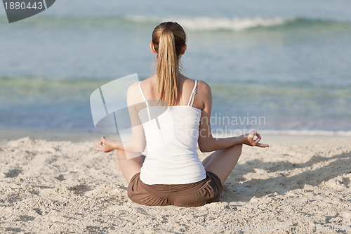 Image of Woman doing yoga on the beach Sports Landscape