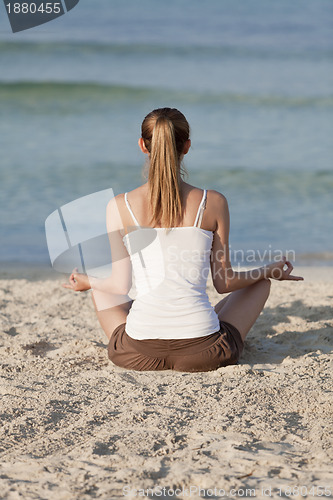 Image of Woman doing yoga on the beach Sports Landscape