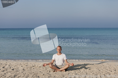 Image of Man making yoga on the beach Sports Landscape