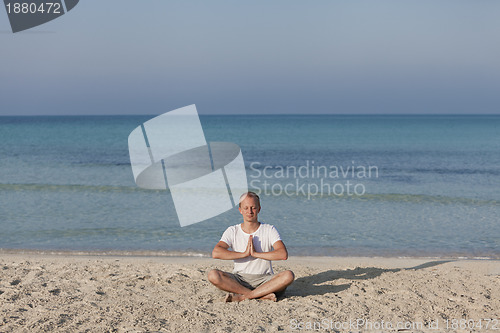 Image of Man making yoga on the beach Sports Landscape