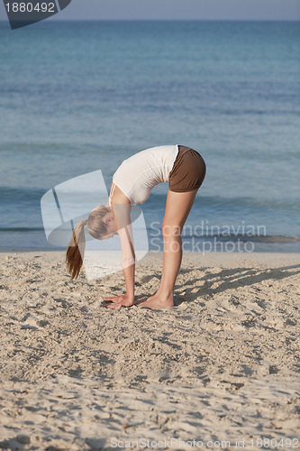 Image of Woman doing yoga on the beach Sports Portrait