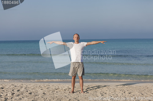 Image of Man making yoga on the beach Sports Landscape