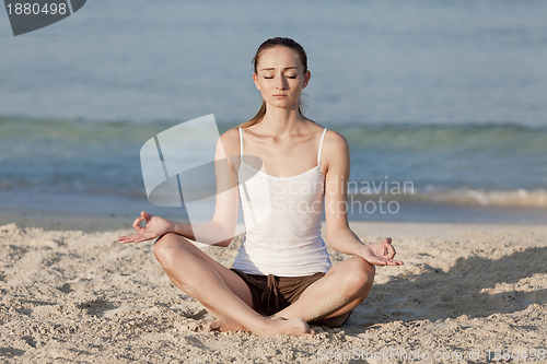 Image of Woman doing yoga on the beach Sports Landscape