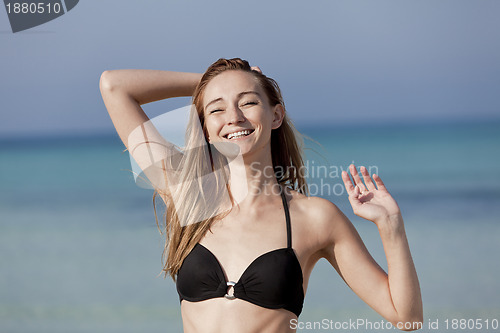 Image of Young woman with bikini on the beach, laughing Portrait Landscap