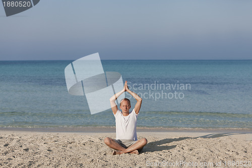 Image of Man making yoga on the beach Sports Landscape