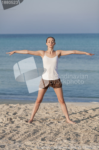 Image of Woman doing yoga on the beach Sports Portrait