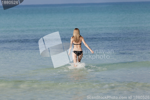 Image of Woman with bikini in the sea jumping landscape