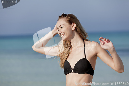 Image of Young woman with bikini on the beach, laughing Portrait Landscap