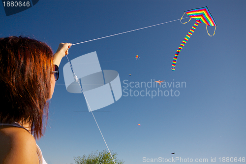 Image of Girl playing with kite