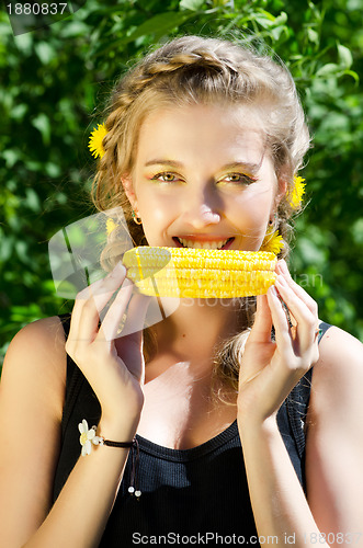 Image of woman eating corn-cob