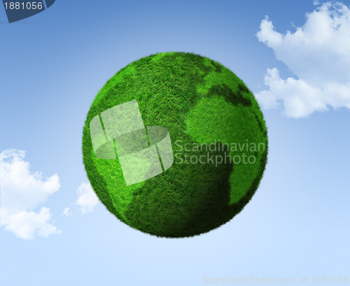 Image of 3D green grass globe on a blue sky