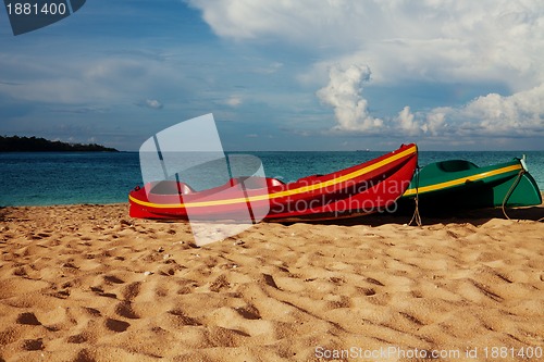 Image of Two kayaks laying on  sand