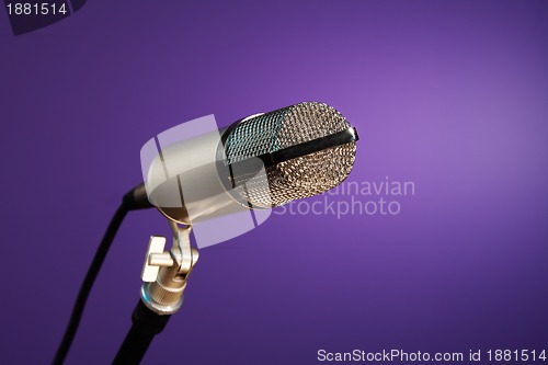 Image of metallic microphone on purple