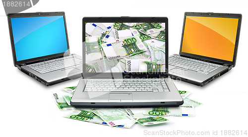 Image of Open laptop with money 