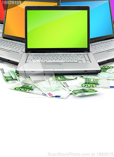 Image of Open laptop with money 