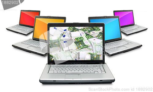 Image of Open laptops with money