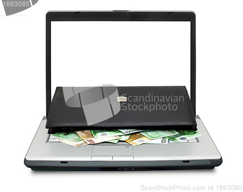 Image of Open laptop with money