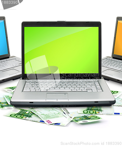 Image of Open laptop with money 