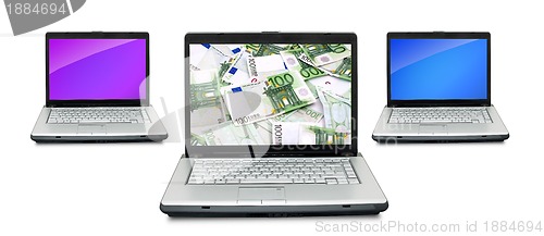 Image of Open laptops with money 
