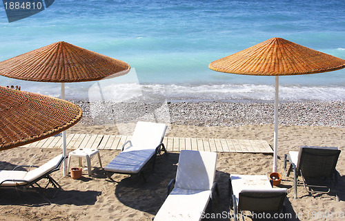 Image of Beach chairs and umbrellas 