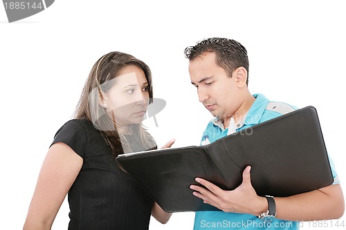 Image of Young beautiful business woman with her employee reading documen