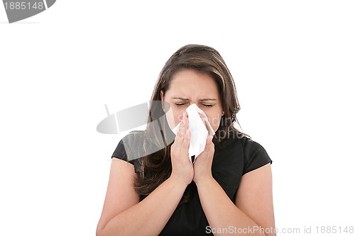 Image of A woman with a cold or allergy wiping or blowing her nose. 