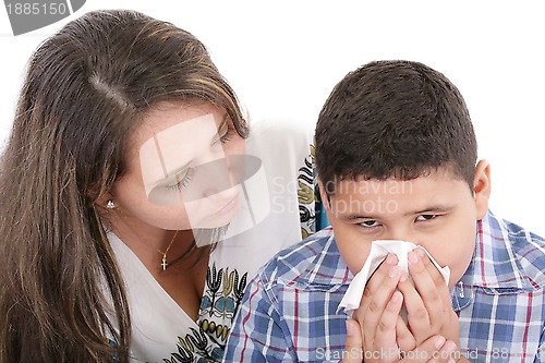 Image of Child blowing nose. Child with tissue. catarrh or allergy 