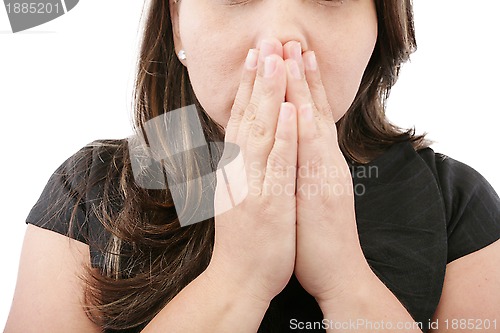 Image of A young woman praying with her hands together on white backgroun