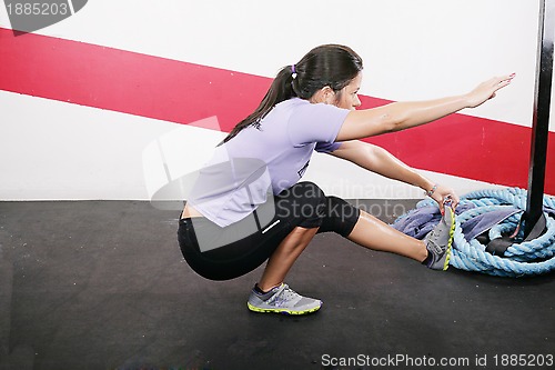 Image of Young Woman Exercising on gym