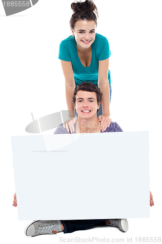 Image of Teens advertising white blank billboard