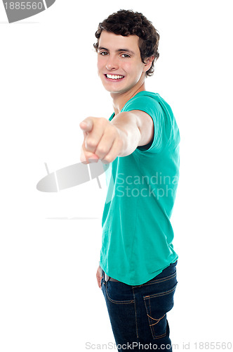 Image of Young guy pointing you out with his stretched left arm