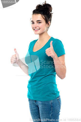 Image of Gorgeous looking casual teenager showing double thumbs up
