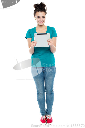 Image of Full length portrait of pretty girl holding tablet pc